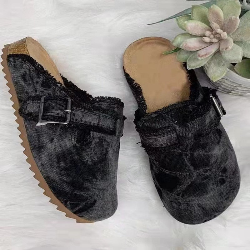  women's faux suede wedge slippers featuring a stylish black design with a buckled strap and cork sole.